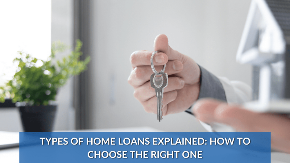 Hand holding house keys next to model