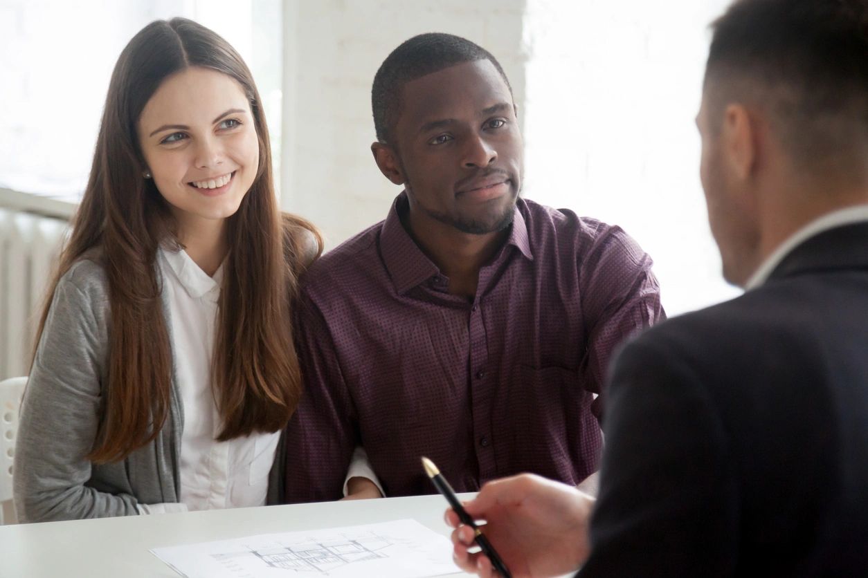 Couple consulting with advisor over documents