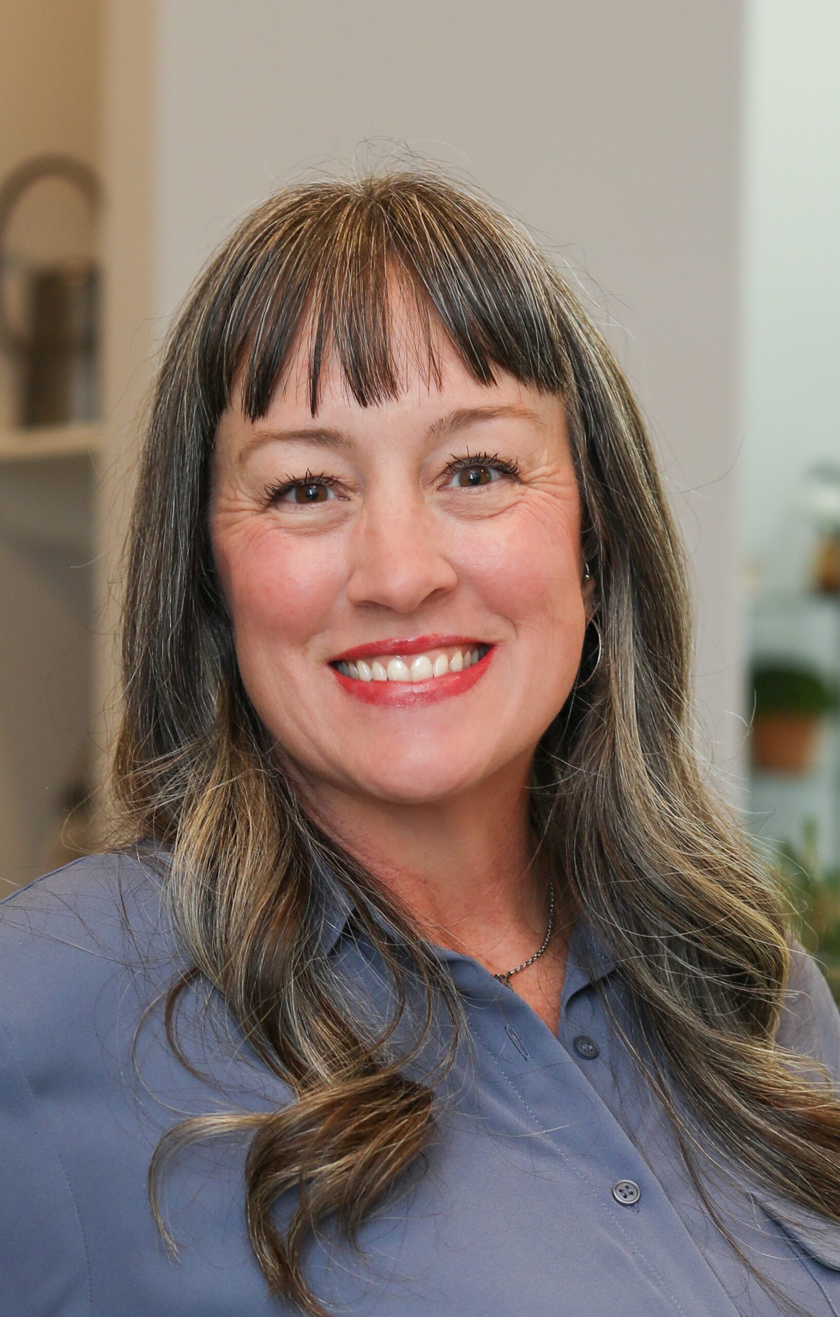 Smiling middle-aged woman with gray-streaked hair