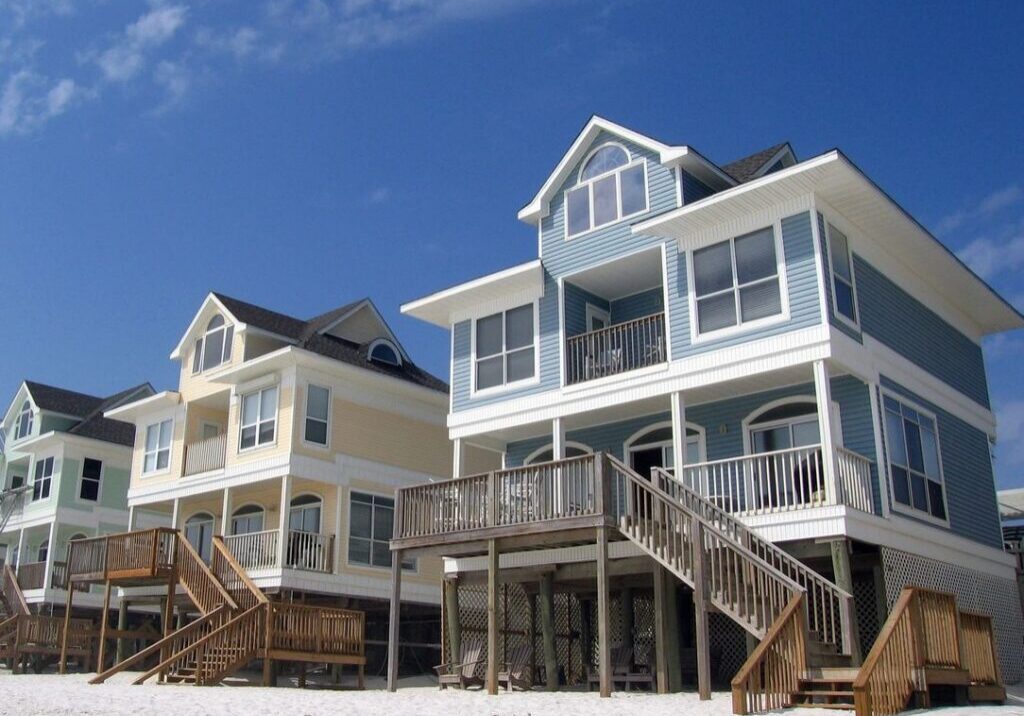 Colorful stilted beach houses on sandy shore