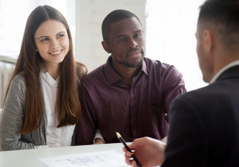 Couple consulting with advisor over documents