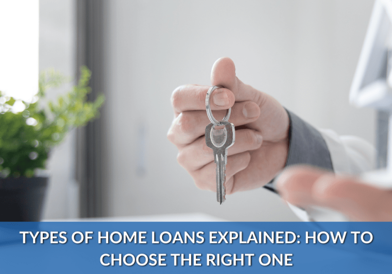 Hand holding house keys next to model